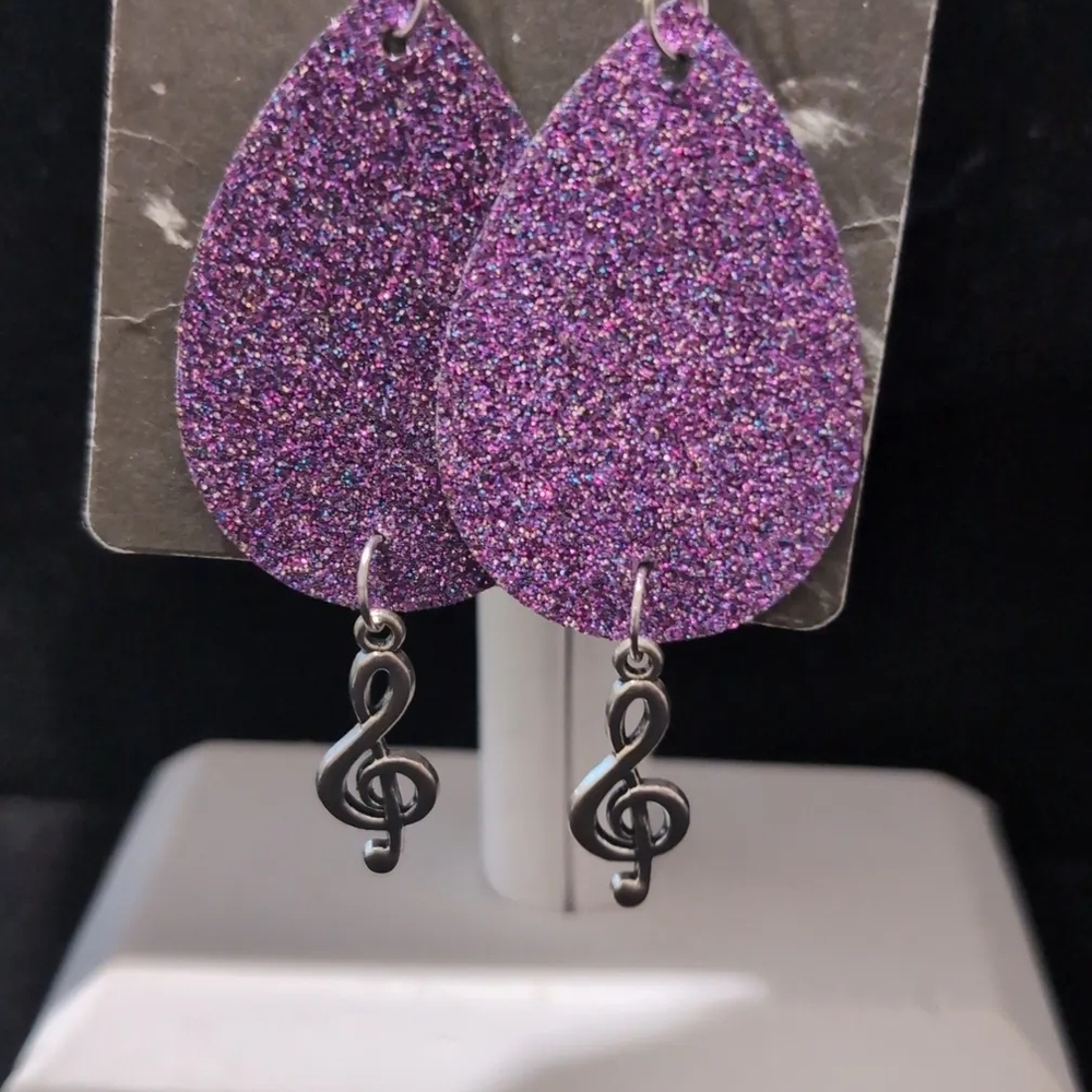 Handmadepurple glitter faux leather teardrop earrings with a treble clef charm